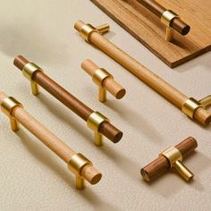 four wooden handles and six brass pulls