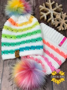 a multicolored hat with pom - pom on top and snowflakes