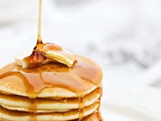 a stack of pancakes with syrup and butter on top