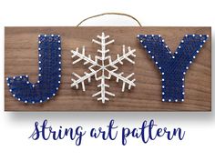 a wooden sign that says joy with snowflakes hanging from the letters on it