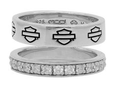 two silver rings with white diamonds on each one and the words love in black lettering