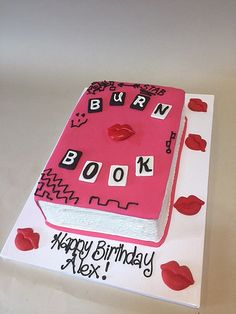 a birthday cake that is shaped like a book