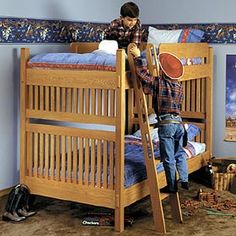 a young boy standing on top of a wooden bunk bed