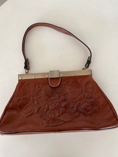 Wonderful, well-made Patricia Nash tooled leather handbag! In like new condition, just lovely and so clean inside and out! Measures 18" wide at bottom, 10" wide at the opening, base is 3" wide. Handle adds an 8 1/2" drop. Wonderful brass closure. Made of Italian leather. Lined with a faux suede, zipper pocket on one side, two slide-in pockets on the other side. So clean! Wonderful gift! Free shipping! Vintage Hand Tooled Tote Satchel, Vintage Hand-tooled Tote Satchel, Vintage Leather Shoulder Bag With Detachable Handle, Vintage Style Hand Tooled Tote Satchel, Vintage Soft Leather Satchel With Double Handle, Classic Hand Tooled Bag For Everyday Use, Classic Hand Tooled Brown Bag, Classic Hand Tooled Leather Bags, Classic Brown Hand Tooled Bag