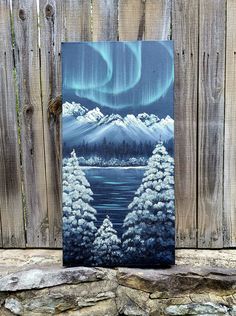 an acrylic painting of the aurora bore over a lake and mountains with snow on it