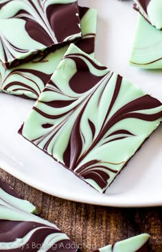 pieces of chocolate and mint green candy on a white plate