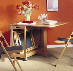 two folding chairs sit in front of a small table with plates and glasses on it