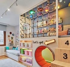 a child's bedroom with lots of toys and decor on the walls, including bookshelves