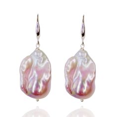 We source our pearls directly from the farms, with no middlemen involved. Each Baroque pearl is guaranteed to be completely natural, with no artificial coloring, preserving its enchanting natural luster. These Silver Pink Baroque Pearl Earrings add a touch of sophistication to any look, making them perfect for any occasion. For a beautifully coordinated ensemble, consider pairing them with our matching pendant from the same collection, further enhancing the overall refinement of your style.   Handmade in London Composition: 925 silver/pearl Handle Gently: Avoid contact with perfumes, cosmetics, and harsh chemicals. Show Love: Clean with a soft cloth and avoid scratching by keeping them separate from other jewelry. Store Safely: When not in use, keep in a jewelry box to maintain their shine Baroque Pearl White Earrings With Pearl Charm, Baroque Pearl Teardrop Earrings With High Luster, High Luster Baroque Pearl Teardrop Earrings, Baroque Pearl Earrings With Pearl Charm, Pear-shaped Pearl Earrings With Ear Wire, Pearl White High Luster Pear Shaped Pearl Earrings, High Luster Baroque Pearl Dangle Earrings, Baroque Pearl Pendant Earrings In Pear Shape, Pearl Drop Earrings With Baroque Pearls