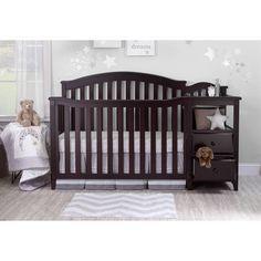 a baby crib in a room with stars on the wall