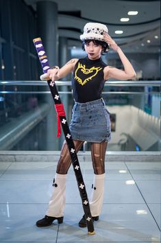 a woman in tights and boots holding a baseball bat with her right hand on top of her head