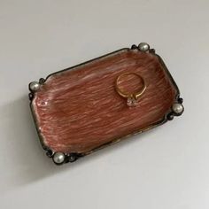 a ring sits on top of a wooden box