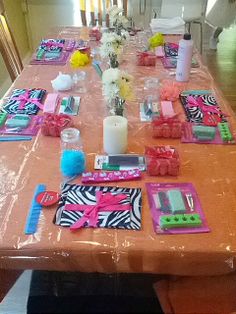 the table is covered with pink and zebra print napkins, place mats, candles, and flowers