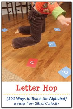 a young child is playing with letters on the floor