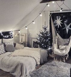 an attic bedroom decorated for christmas with lights and hammock hanging from the ceiling