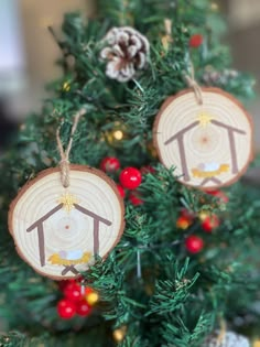 two ornaments are hanging from a christmas tree