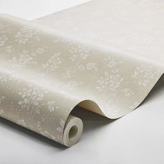 an image of a wallpaper with white flowers and leaves on the side, as well as a roll of tape