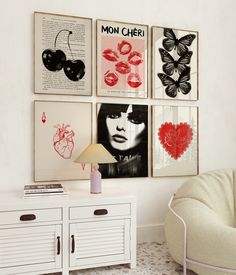 a white cabinet sitting next to a wall with pictures on it