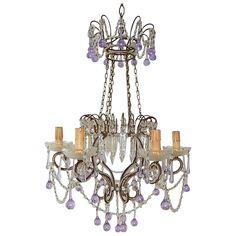 a chandelier with purple glass beads hanging from it