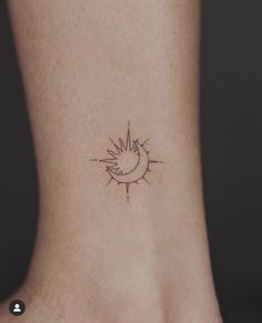 a small sun and moon tattoo on the side of a woman's foot,