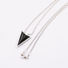 Super cool designer arrow pendant made from sterling silver and black onyx. This pendant necklace is handmade by a family run business of highly skilled craftsmen. It's quality and finish are second to none. The highest grade black onyx is used. Be the envy of your friends, with this superb quality master craftsman made piece. Pendant: Sterling silver & Black onyx. Pendant size: 23mm x 13mm / 0.9" x 0.5". Chain: Sterling silver Chain lengths: 50cm, 60cm, 70cm / 20", 24", 28". The model is wearin Sterling Silver Necklace With Black Enamel, Sterling Silver Pendant Necklace With Black Enamel, Modern Silver Necklace With Black Enamel, Black Sterling Silver Necklaces With Polished Finish, Minimalist Black Sterling Silver Necklaces, Black Sterling Silver Necklace With Polished Finish, Minimalist Black Sterling Silver Necklace, Modern Black Sterling Silver Necklace, Modern Black Necklace With Polished Finish