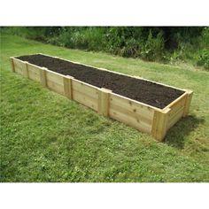 a large wooden garden bed in the grass