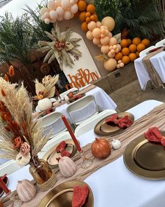 a table is set with plates and place settings for an autumn themed dinner or party