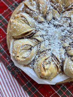 a pastry on a plate covered in powdered sugar