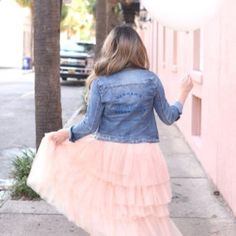 a woman is walking down the sidewalk with a balloon