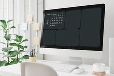 a computer monitor sitting on top of a white desk next to a keyboard and mouse