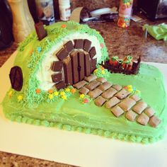 a cake that looks like a hobbot house with a train coming out of it