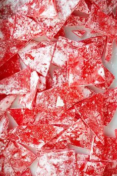 some red and white pieces of glass that have been cut into small squares on top of each other