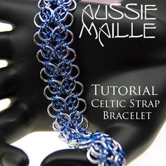 the chain bracelet is made with blue and silver metal links, which are attached to a black plastic mannequin