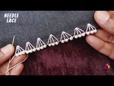 someone is stitching something on the side of a piece of fabric with white thread