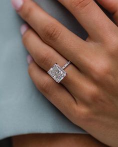 a woman's hand with a diamond ring on it