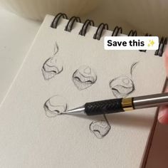 someone is drawing faces on a piece of paper with a pen and inking it