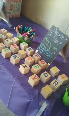 a purple table topped with lots of wooden blocks and diced numbers on top of it