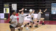 the girls are playing volleyball on the court and ready to hit the ball with their hands