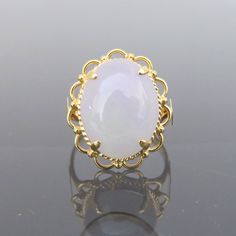 Vintage 18K Solid Yellow Gold Oval Natural Purple Lavender, Green Jadeite Jade Filigree Ring....Marked 18k ...Total of weights 5.2grams...Size 7.5...Measure of Jade 16.7 x 13MMIt's in very good condition.  #441921  A01 Elegant Oval Moonstone Ring In Chalcedony, Elegant Oval Moonstone Chalcedony Ring, Gold Cabochon Gemstones For Wedding, Vintage White Moonstone Ring In Oval Cabochon, Elegant Chalcedony Opal Ring, Vintage Chalcedony Round Jewelry, Elegant Chalcedony Opal Ring For Anniversary, Vintage Chalcedony Jewelry, Formal Chalcedony Rings In Fine Jewelry Style