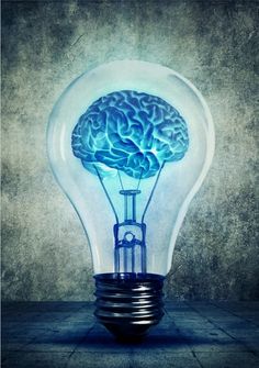 a light bulb with a brain in it's center on a concrete floor against a grungy background