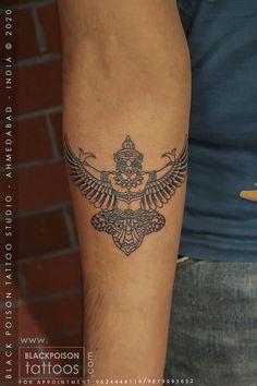 a man's arm with a tattoo on it and an eagle in the middle