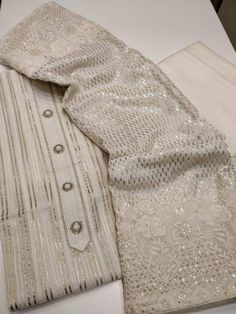 Item Overview Atharva Salwar Kameez w/Beautiful Hand Embroidery Gota work on Cream Chanderi & Cream Georgette Dupatta w/Heavy Sequence work.- GE9007 Dno. GE9007 Fabric: * Shirt Chanderi - Cream 2.5 Mts, with Beautiful Neck Embroidery and Jaal. * Dupatta: Georgette Dupatta in Cream. All over Sequence work and embroidery on side with Elegant Moti Latkans * Bottom White Santoon Silk 2.5 Mts. Excusive Hand Embroidered Party Wear Punjabi Suit. Customization: * Fabrics: Designs Can be made in differen