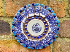 This one off bespoke circular mosaic garden wall plaque is made with willow pattern china. It measures 6.5 x 6.5 inches (17 x 17cms) and is finished with brown grout. It is fully weatherproof and is sure to brighten up any garden wall or indoor living space. It would make a unique gift for someone who loves their garden. This handmade wall art would benefit from being placed where the sunlight catches it so you can see how it sparkles and shines. Although I have taken every care to make sure the Brown Grout, Circular Mosaic, Mothers Day Art, Garden Wall Plaque, Mother's Day Art, China Mosaic, Round Garden, Willow Pattern, Mosaic Garden