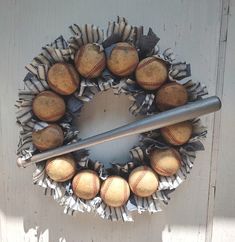 a wreath with baseballs and a bat on it