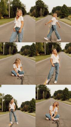 a woman is sitting on the ground in front of an empty road and posing for pictures