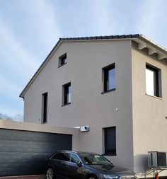 two cars are parked in front of a house