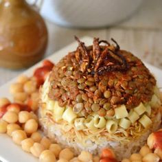 a white plate topped with rice covered in beans