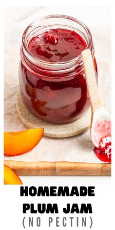 homemade plum jam in a glass jar with a wooden spoon