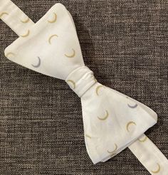 You'll love this Crescent Moons Bow Tie for a mysterious look! Comes in multiple colours. -Pre-tied but can be re-tied -Back clasp -Adjustable -13.5 cm wide X 6 cm high -39.5 cm to 52.5 cm long White Adjustable Standard Tie, Adjustable White Bow Tie, White Adjustable Standard Bow Tie, Adjustable White Bow For Black Tie Occasion, White Adjustable Bow Tie For Black Tie Occasions, Adjustable Standard Tie Bow For Summer, Adjustable Summer Bow Ties, Adjustable Butterfly Knot Tie, Adjustable Bow Tie With Butterfly Knot For Summer