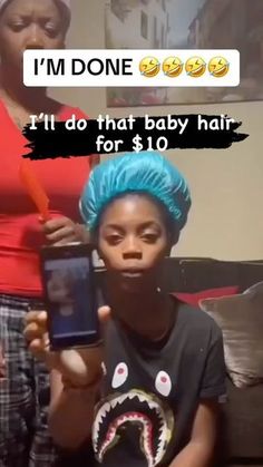 a young boy with blue hair is holding up a cell phone